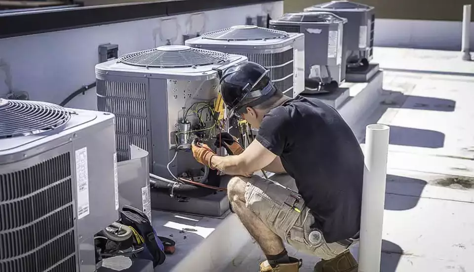  An Action Air technician working on a commercial HVAC system